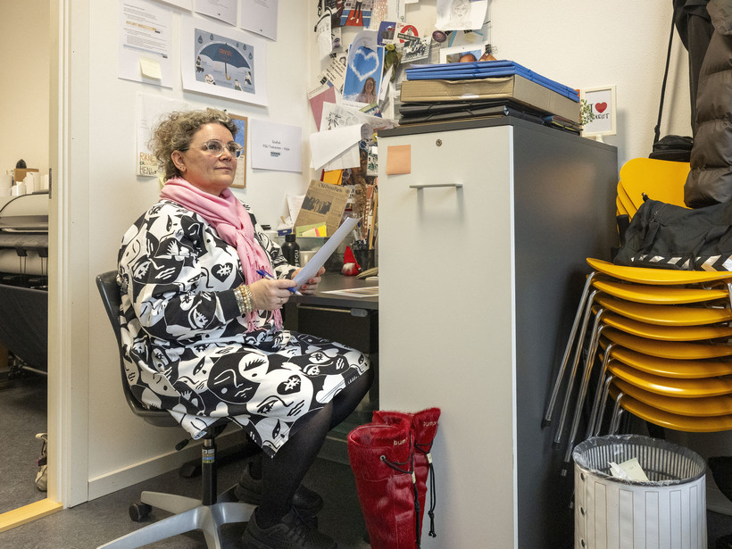 lærer ved arbejdsplads med papir i hånden